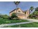 Elegant home with a three-car garage, lush green lawn, and mature landscaping at 3322 Cypress Landing Dr, Valrico, FL 33596
