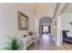 Inviting foyer with high ceilings, ornate mirror, stylish furniture, and wood flooring at 3322 Cypress Landing Dr, Valrico, FL 33596