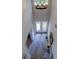 Grand two-story foyer with a decorative chandelier, wood-look flooring, and double front doors at 3322 Cypress Landing Dr, Valrico, FL 33596