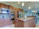 Modern kitchen with stainless steel appliances, granite countertops, island and wood cabinets at 3322 Cypress Landing Dr, Valrico, FL 33596