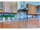 Gourmet kitchen boasts sleek cabinetry, mosaic backsplash, and stainless steel range hood at 3322 Cypress Landing Dr, Valrico, FL 33596