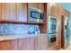 Modern kitchen with stainless steel appliances, granite countertops, and custom cabinets at 3322 Cypress Landing Dr, Valrico, FL 33596