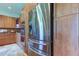 Stainless steel refrigerator and built-in oven in a modern kitchen setting at 3322 Cypress Landing Dr, Valrico, FL 33596