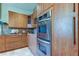Modern kitchen with stainless steel double ovens and custom wood cabinetry at 3322 Cypress Landing Dr, Valrico, FL 33596