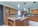 Kitchen island with granite countertop, custom cabinets, and stainless steel appliances at 3322 Cypress Landing Dr, Valrico, FL 33596