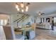 Open concept living and dining area with modern lighting and staircase in the background at 3322 Cypress Landing Dr, Valrico, FL 33596