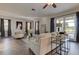Inviting living room with neutral decor, wood floors, and a view of the outdoor pool at 3322 Cypress Landing Dr, Valrico, FL 33596