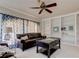 Inviting living room with built-in bookshelves, ceiling fan, and a comfortable seating area at 3322 Cypress Landing Dr, Valrico, FL 33596
