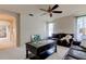 Cozy living room with arched doorway, ceiling fan, and comfortable leather seating at 3322 Cypress Landing Dr, Valrico, FL 33596
