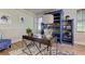 Stylish home office featuring a modern desk, built-in blue shelving, and accent furniture at 3322 Cypress Landing Dr, Valrico, FL 33596