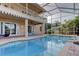 Spacious screened-in lanai with pool features an upper balcony overlooking the backyard at 3322 Cypress Landing Dr, Valrico, FL 33596