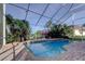 Inviting screened-in pool area features a brick patio and lush tropical foliage at 3322 Cypress Landing Dr, Valrico, FL 33596