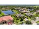 Aerial shot of a home with beautiful landscaping and a tranquil pond view, providing a peaceful and private setting at 347 Cockle Shell Loop, Apollo Beach, FL 33572