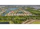 A home with a well-manicured lawn in a lakeside community featuring a network of lakes and mature landscaping throughout at 347 Cockle Shell Loop, Apollo Beach, FL 33572