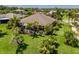 Aerial view of backyard with enclosed patio and lush tropical landscaping at 347 Cockle Shell Loop, Apollo Beach, FL 33572