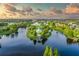 Stunning aerial view of community gazebo and surrounding landscaping on an island in the pond at 347 Cockle Shell Loop, Apollo Beach, FL 33572