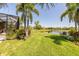 Beautiful, green backyard features an enclosed patio and a pond view at 347 Cockle Shell Loop, Apollo Beach, FL 33572