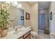 A well-lit bathroom features tiled floors, a light countertop, and a tiled shower at 347 Cockle Shell Loop, Apollo Beach, FL 33572