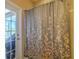 Neutral bathroom with a shower, decorative curtain, and a glass door to patio at 347 Cockle Shell Loop, Apollo Beach, FL 33572