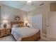 Bright bedroom with a ceiling fan, a cozy bed and carpet flooring at 347 Cockle Shell Loop, Apollo Beach, FL 33572