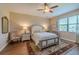 Traditional Primary bedroom with wood flooring, a ceiling fan, and a decorative rug at 347 Cockle Shell Loop, Apollo Beach, FL 33572