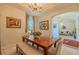 Dining room with tray ceiling, chandelier, and a wooden table with bench seating at 347 Cockle Shell Loop, Apollo Beach, FL 33572