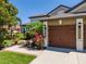 Lovely home featuring a three-car garage, and a colorful landscaped garden at entry at 347 Cockle Shell Loop, Apollo Beach, FL 33572