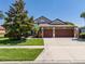 Lovely home displaying a three-car garage, green lawn, and colorful landscaping at 347 Cockle Shell Loop, Apollo Beach, FL 33572