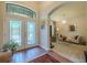 Elegant foyer showcasing decorative glass doors, arched entryways, and a view of the living room at 347 Cockle Shell Loop, Apollo Beach, FL 33572