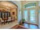 Beautiful foyer featuring decorative glass doors, tiled floor, archways and a dining room at 347 Cockle Shell Loop, Apollo Beach, FL 33572