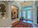 Welcoming foyer featuring decorative glass doors, archways, and a glimpse of the dining room at 347 Cockle Shell Loop, Apollo Beach, FL 33572
