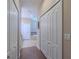 Hallway with wood floors leading to a bathroom with a soaking tub at 347 Cockle Shell Loop, Apollo Beach, FL 33572