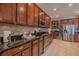 Spacious kitchen features stainless steel appliances, dark wood cabinets, and granite countertops at 347 Cockle Shell Loop, Apollo Beach, FL 33572