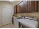 Featuring a modern washer and dryer set and dark brown upper cabinets at 347 Cockle Shell Loop, Apollo Beach, FL 33572