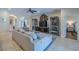 Spacious living room with tile flooring, comfortable seating, display cabinets, and a large television at 347 Cockle Shell Loop, Apollo Beach, FL 33572
