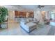 Open-concept living area and kitchen with tile floors, modern furnishings, and natural light at 347 Cockle Shell Loop, Apollo Beach, FL 33572