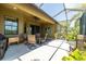 Outdoor enclosed patio has ample seating, ceiling fan, and landscaped views at 347 Cockle Shell Loop, Apollo Beach, FL 33572