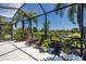Enclosed patio features outdoor seating and beautiful landscaping around pond at 347 Cockle Shell Loop, Apollo Beach, FL 33572