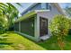 View of the grassy backyard and screened lanai, ideal for outdoor enjoyment at 3714 W San Juan St, Tampa, FL 33629