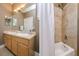 Well-lit bathroom featuring a double vanity sink and shower with a tub at 3714 W San Juan St, Tampa, FL 33629