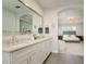 Bright bathroom with double sink vanity, granite counters, and ensuite bedroom at 3714 W San Juan St, Tampa, FL 33629