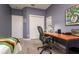 Multi-purpose bedroom featuring a desk, a bed, and a ceiling fan at 3714 W San Juan St, Tampa, FL 33629