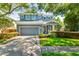Charming two-story home with a well-manicured lawn, mature trees, and a gray exterior paint scheme at 3714 W San Juan St, Tampa, FL 33629