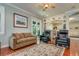 Cozy living room with hardwood floors, an area rug, built-in bookcases, and french doors at 3714 W San Juan St, Tampa, FL 33629