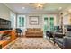 Spacious living room with hardwood floors, built in bookcases, an area rug, and neutral paint at 3714 W San Juan St, Tampa, FL 33629