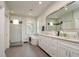 Luxurious main bathroom with a standalone tub, walk-in shower, and dual vanity sinks at 3714 W San Juan St, Tampa, FL 33629