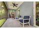Comfortable screened porch featuring furniture, ceiling fan, and a grill at 3714 W San Juan St, Tampa, FL 33629