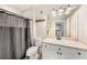 A well-lit bathroom with a neutral vanity, large mirror, and tub-shower combination, exudes a clean and functional style at 4221 W Spruce St # 2104, Tampa, FL 33607