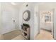 Hallway view with a console table and mirror, leading to the bathroom and other rooms at 4221 W Spruce St # 2104, Tampa, FL 33607