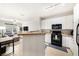 Open kitchen overlooking the living area, with white cabinets and a view of the patio at 4221 W Spruce St # 2104, Tampa, FL 33607